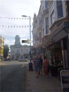 a group of people walking down a city street at Apartment 2, Aberystwyth Town Centre in Aberystwyth