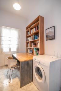 a laundry room with a washing machine and a desk at Evangelia's Mansion in Naxos Chora