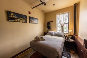 a bedroom with a bed with a pair of shoes on it at Traveler's Rest Hotel in Pittsburgh