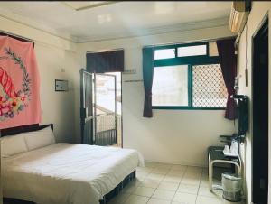 a bedroom with a bed and a window at Forever Happiness Hostel in Puli