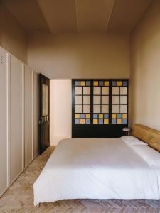 a bedroom with two beds and a window at Fàbrica Descals and Pavillion in Olot