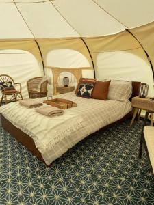 a bedroom with a bed in a tent at Immaculate Lotus Belle Tent Retreat North Devon in Bideford