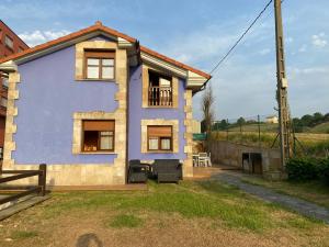 una pequeña casa azul con patio en Casa Balmori El Peral, en Ribadedeva