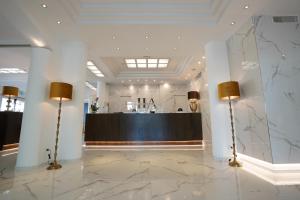 a lobby with two lamps and a bar in the background at Hotel Arizona in Riccione