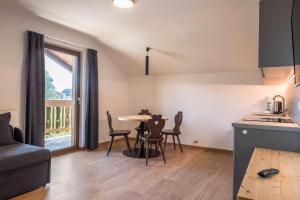 a kitchen and living room with a table and chairs at Nigglhof Apartment Maria in Redagno