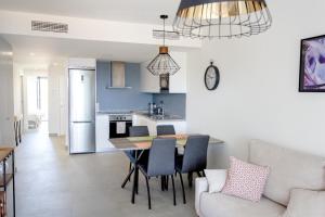 a kitchen and living room with a table and chairs at Blue Sunset Manilva in Manilva