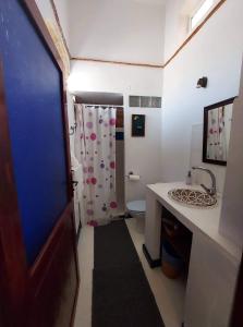 a bathroom with a toilet and a shower curtain at Riad Le Cheval Blanc in Safi