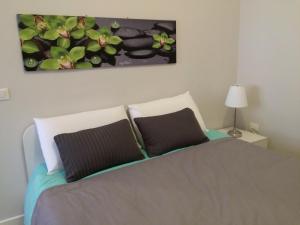 a bedroom with a bed with a painting on the wall at Pescara Center Apartment in Pescara