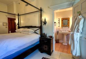 a bedroom with a large bed and a sink at Wedmore Place in Williamsburg