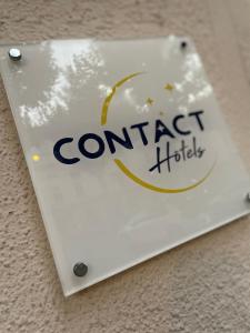 a sign for a cond target hotel on a table at Contact Hôtel les Platanes - Clim Mobile en Option in Villeneuve-sur-Lot +32 photos