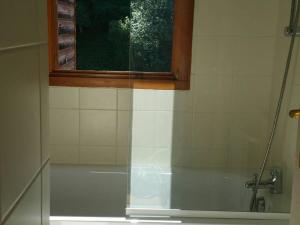 a bathroom with a shower with a window and a tub at Studio Valloire, 1 pièce, 2 personnes - FR-1-263-483 in Valloire