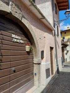 a wooden garage door with a flower pot on it at Maison Annabelle in Ceniga