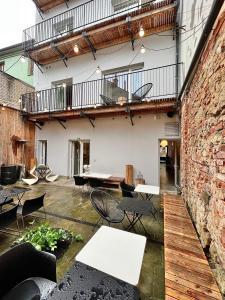 an outdoor patio with tables and chairs and a brick building at Boutique REZIDENCE BAAR in Nový Jičín