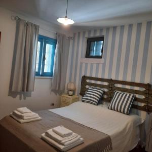- une chambre avec un lit et des serviettes dans l'établissement TRULLO PIETRAPOESIA, à Ostuni