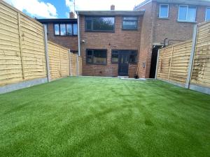 a large yard with green grass in front of a building at Entire Luxury Holiday Home leeds in Beeston