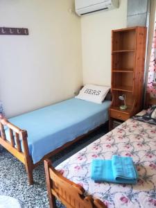 a bedroom with two beds and a dresser at Stamatia's House in Haraki