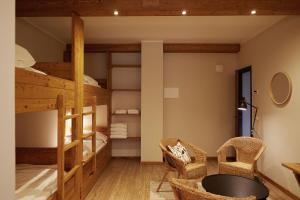 a room with bunk beds and a table and chairs at Hotel Monterosa in Alagna Valsesia