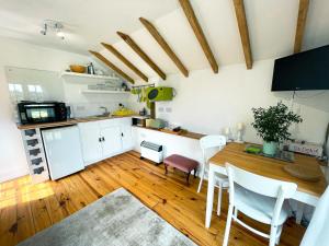 a kitchen and dining room with a table and chairs at Holmdale Holiday Cottages in Rye +14 photos