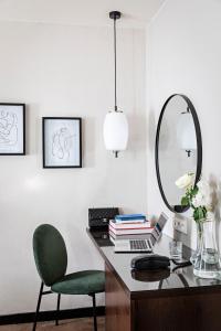 - un bureau avec une chaise verte et un miroir dans l'établissement Holiday Inn Paris Elysées, an IHG Hotel, à Paris