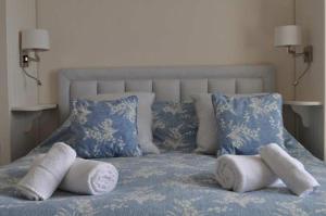 a bed with white towels and pillows on it at Gorgeous Apartment only yards from Polzeath Beach in Wadebridge