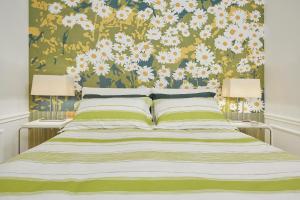 a bedroom with a bed with a floral wallpaper at Villa Ulisse - Suites - Luxury B&B in Numana