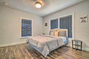 a bedroom with a bed and two windows at Charming and Quaint El Paso House with Backyard! in El Paso