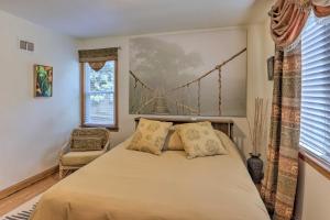 a bedroom with a bed and a bridge painting on the wall at Pet-Friendly Whitefish Bay Getaway with Large Yard! in Whitefish Bay