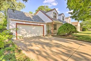 a house with a garage and a driveway at Pet-Friendly Whitefish Bay Getaway with Large Yard! in Whitefish Bay