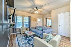 a living room with a blue couch and chairs at Charming San Antonio Home about 4 Mi to Downtown in San Antonio