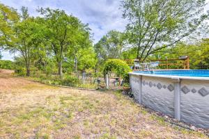 an outdoor swimming pool in a yard with trees at Secluded Weatherford Cottage with Outdoor Pool! in Willow Park