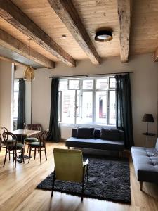 a living room with a couch and a table and chairs at Boutique REZIDENCE BAAR in Nový Jičín