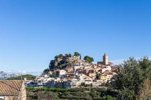 a village on top of a hill with houses at LEON DORMIDO Rooms & Apartments in Polop