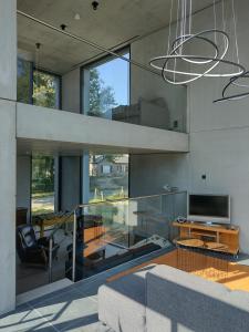 a living room with a couch and a tv at The Kettle House - Manor in Sint-Pieters-Leeuw