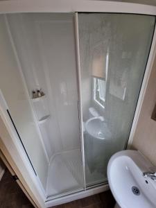 a bathroom with a shower and a sink at Willow-Static Caravan on Holiday Park near Margate, Kent in Kent