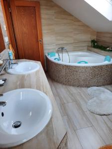 ein Badezimmer mit zwei Waschbecken und einer Badewanne in der Unterkunft Apartmán Mikulov in Mikulov