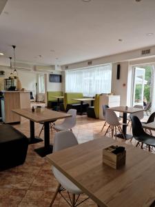 a large room with tables and chairs and a room withwindows at Guest House KAKTUS in Rīga