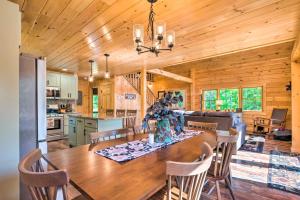 a dining room and kitchen with a table and chairs at Wooded North Haverhill Haven with Wood Fire Pit 