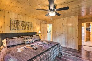 a bedroom with a bed and a ceiling fan at Wooded North Haverhill Haven with Wood Fire Pit 