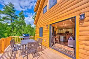 a patio with a table and chairs on a wooden deck at Wooded North Haverhill Haven with Wood Fire Pit 