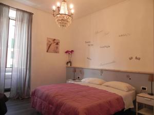 a bedroom with a bed and a chandelier at Vica Pota in Rome