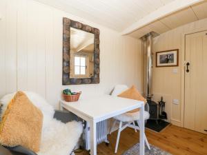 a room with a white table and a mirror at The Hut in Nymphsfield