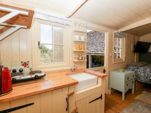 a kitchen with a sink and a window at The Hut in Nymphsfield
