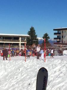アルバールにあるStudio avec terrasse amenagee et wifi a Allevardの遊び場前の雪上に立つスノーボード