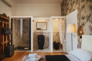 a bedroom with a bed and a shower in it at SUITE COLOSSEO in Rome