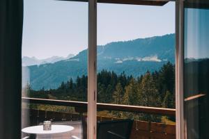 a window with a view of a mountain at Alpengasthof Hörnlepass in Riezlern