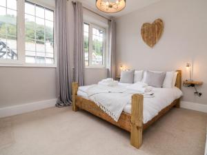 a bedroom with a large bed with a heart on the wall at Wood Cottage in Lynton
