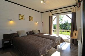a bedroom with a bed and a sliding glass door at Domaine Saint Esteve in Millau