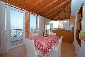 a dining room with a table and a view of the ocean at A View from the Attic Window. Kyparissia, Messinia in Kyparissia