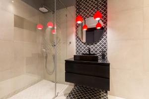 a bathroom with a shower and a sink and a mirror at Cadena Gallery Apartments Matejko in Krakow