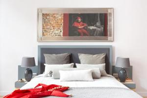 a bedroom with a bed with a red bow on it at Cadena Gallery Apartments Matejko in Krakow